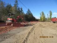 Construction crews finish up preparing the site, clearing old landscaping, etc.