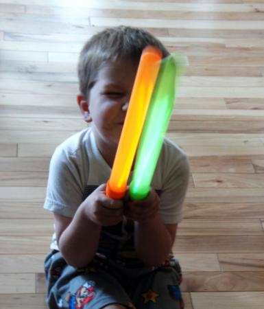Kid holding two toy DIY light sabers