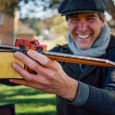 Keeth Apgar with a toy firetruck balancing on an instrument